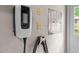 Close up of an EV charger installed on a garage wall at 220 Dalton Dr, Raleigh, NC 27615