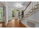 Entryway featuring hardwood flooring, staircase, and arched doorway at 220 Dalton Dr, Raleigh, NC 27615