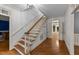This entry features a hardwood staircase with white trim, and doors leading into other rooms at 220 Dalton Dr, Raleigh, NC 27615
