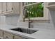 Close up of sink with gooseneck faucet, quartz countertop and subway tile backsplash at 220 Dalton Dr, Raleigh, NC 27615