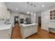 Open kitchen with stainless appliances, an island with cooktop, and view to dining room at 220 Dalton Dr, Raleigh, NC 27615