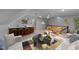 Open living room features a bar, foosball table, seating, and decorative elements at 220 Dalton Dr, Raleigh, NC 27615