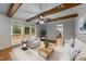 Bright living room with wooden beams, access to the deck and entry to kitchen space at 220 Dalton Dr, Raleigh, NC 27615