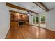 Cozy living room features wood beams, built-in cabinets, fireplace and glass doors to the deck at 220 Dalton Dr, Raleigh, NC 27615