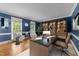 This is a stylish home office with custom bookshelves, desk, two sitting chairs, and a neutral area rug at 220 Dalton Dr, Raleigh, NC 27615