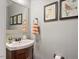 Tastefully decorated half-bath with a decorative mirror and neutral paint at 2207 Cameron Pond Dr, Cary, NC 27519