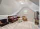 Bonus room featuring a sofa, armchair, and TV, perfect for relaxing at 2207 Cameron Pond Dr, Cary, NC 27519