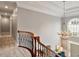Elegant foyer featuring a staircase with dark ironwork and a chandelier at 2207 Cameron Pond Dr, Cary, NC 27519
