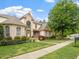 Charming home exterior with manicured lawn, mature trees, and a well-maintained landscape at 2207 Cameron Pond Dr, Cary, NC 27519