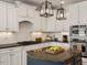 Elegant white kitchen features a large center island and updated appliances at 2207 Cameron Pond Dr, Cary, NC 27519