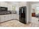 Well-equipped kitchen featuring white cabinets and modern black appliances at 2207 Cameron Pond Dr, Cary, NC 27519