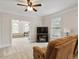 Bright living room with fireplace and view into another cozy seating area at 2207 Cameron Pond Dr, Cary, NC 27519