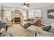 Cozy living room featuring a fireplace, plush seating, and an open layout leading to the kitchen at 2207 Cameron Pond Dr, Cary, NC 27519