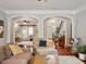 Inviting living room featuring arched doorways and hardwood floors at 2207 Cameron Pond Dr, Cary, NC 27519