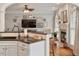 The open floor plan allows the kitchen to flow into the living room with a fireplace at 2207 Cameron Pond Dr, Cary, NC 27519