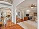 Open-concept living space with hardwood floors, a fireplace, and arched doorways to the adjacent spaces at 2207 Cameron Pond Dr, Cary, NC 27519