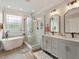 Beautiful main bathroom featuring double vanity, freestanding tub, and glass shower at 2207 Cameron Pond Dr, Cary, NC 27519