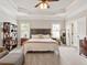 Spacious main bedroom with tray ceiling, two windows, and ample natural light at 2207 Cameron Pond Dr, Cary, NC 27519