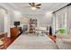 Multipurpose room with hardwood floors, office furniture, and dining space with lots of light at 2207 Cameron Pond Dr, Cary, NC 27519