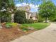 Manicured yard and landscaping surrounding a home with mature trees and manicured lawn at 2207 Cameron Pond Dr, Cary, NC 27519