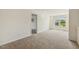 Spacious bedroom with plush carpeting, a neutral color scheme, and a window offering natural light at 225 Rosewood Ln, Youngsville, NC 27596