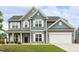 Charming two-story home with gray siding, white trim, and a well-manicured lawn, showing great curb appeal at 225 Rosewood Ln, Youngsville, NC 27596