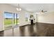 Spacious living room featuring hardwood floors, a fireplace with built-in shelving, and sliding glass doors at 225 Rosewood Ln, Youngsville, NC 27596
