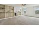 Bright main bedroom with carpeted floors, built-in shelving, and a ceiling fan at 225 Rosewood Ln, Youngsville, NC 27596