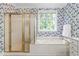 Elegant bathroom with floral wallpaper, a soaking tub, and a separate shower at 228 Birch Creek Dr, Fuquay Varina, NC 27526