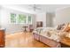 Cozy bedroom with hardwood floors, multiple windows, and classic furnishings at 228 Birch Creek Dr, Fuquay Varina, NC 27526