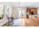 A dining area with hardwood floors, a blue rug, two chairs, and windows that allow plenty of natural light at 228 Birch Creek Dr, Fuquay Varina, NC 27526