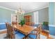 Traditional dining room featuring striped wallpaper, wood table, and decorative chandelier at 228 Birch Creek Dr, Fuquay Varina, NC 27526
