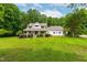 Beautifully landscaped front yard with a classic white home and inviting porch at 228 Birch Creek Dr, Fuquay Varina, NC 27526