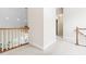 Second-floor hallway with carpet flooring and railing overlooking the living room at 228 Birch Creek Dr, Fuquay Varina, NC 27526