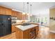 Bright kitchen with wooden cabinets, a center island cooktop, stainless steel appliances and under cabinet lighting at 228 Birch Creek Dr, Fuquay Varina, NC 27526