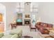 Open-concept living area with a stone fireplace, high ceilings, and neutral decor at 228 Birch Creek Dr, Fuquay Varina, NC 27526