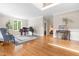 Open-concept living room with hardwood floors, a piano, and a staircase at 228 Birch Creek Dr, Fuquay Varina, NC 27526