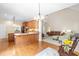 An open floor plan combines the kitchen, dining, and living areas with hardwood floors and views of the backyard at 228 Birch Creek Dr, Fuquay Varina, NC 27526