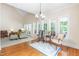 Sun-filled living area with hardwood floors and a charming sitting area with a patterned rug at 228 Birch Creek Dr, Fuquay Varina, NC 27526