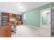 An office area with a custom built in bookcase and a desk, bathed in natural light from a window at 228 Birch Creek Dr, Fuquay Varina, NC 27526