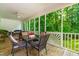 Screened-in porch with a ceiling fan and a table and chairs at 228 Birch Creek Dr, Fuquay Varina, NC 27526