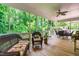 Relaxing screened-in porch with wicker furniture and views of the surrounding greenery at 228 Birch Creek Dr, Fuquay Varina, NC 27526