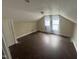 Large attic featuring hardwood floors, two windows and a door to closet at 2503 Chapel Hill Rd, Durham, NC 27707