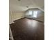 Attic space featuring hardwood floors, two windows, and neutral paint at 2503 Chapel Hill Rd, Durham, NC 27707