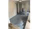 Unfinished basement space with painted concrete floor, exposed brick columns, and natural light at 2503 Chapel Hill Rd, Durham, NC 27707