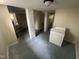 View of the unfinished basement with painted floor and laundry area at 2503 Chapel Hill Rd, Durham, NC 27707