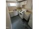 Unfinished basement kitchen featuring white cabinets and appliances at 2503 Chapel Hill Rd, Durham, NC 27707