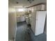 Unfinished basement kitchen with white appliances and painted floor at 2503 Chapel Hill Rd, Durham, NC 27707