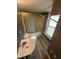 Compact bathroom with a shower/tub combo, updated vanity, and a window for natural light at 2503 Chapel Hill Rd, Durham, NC 27707
