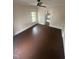 Bright bedroom with hardwood floors, ceiling fan and natural light from the large window at 2503 Chapel Hill Rd, Durham, NC 27707